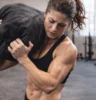 Athlete shouldering a sandbag