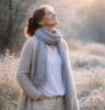 Contented looking lady, standing outside in nature, raising her face to the wintery sun