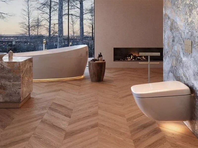 Luxury bathroom with herringbone wood floors and freestanding bathtub