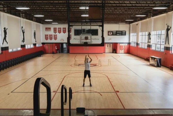 Man practising free throws in an indoor basketball gymnasium