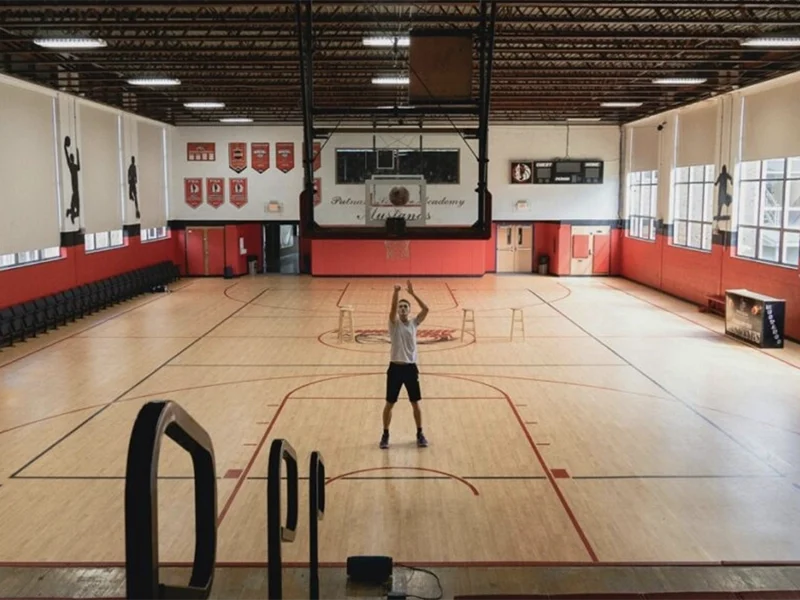 Man practising free throws in an indoor basketball gymnasium