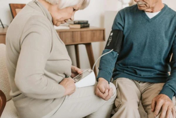 woman taking man's blood pressure
