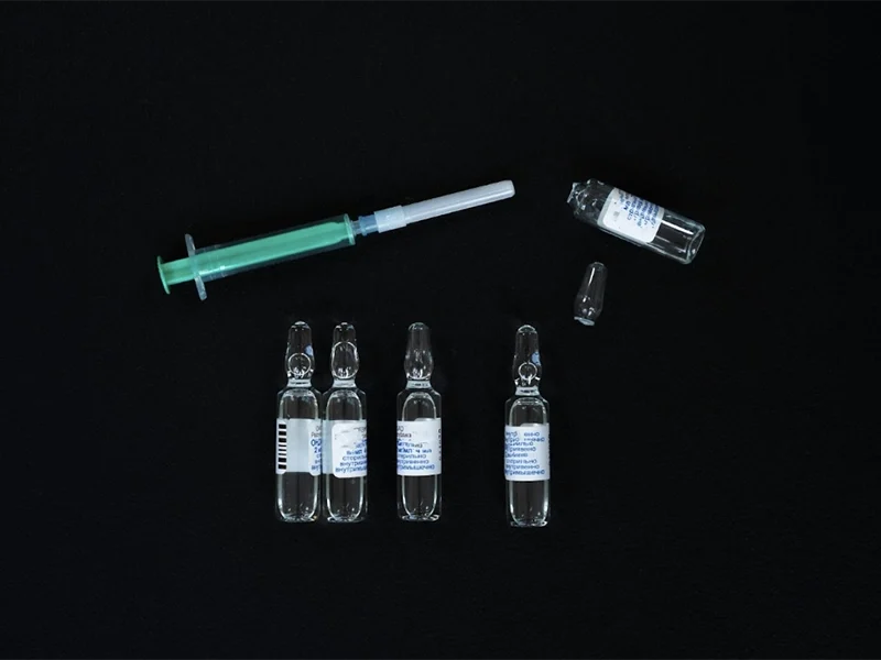 Five vials and a syringe, courtesy of Mikhail on Pexels