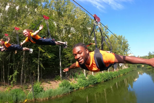 three people on a zipline