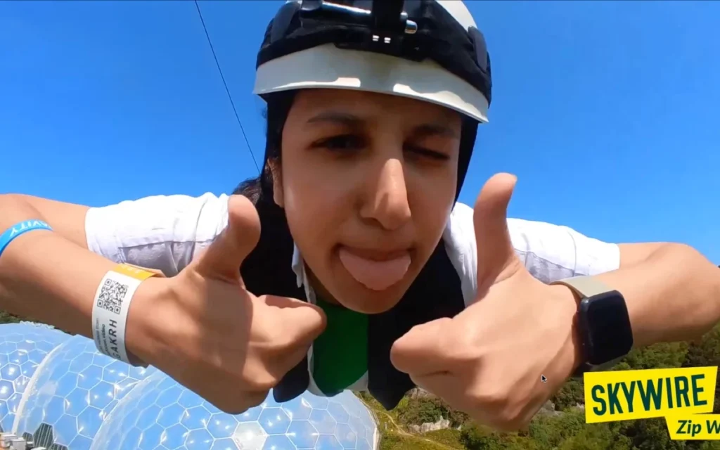 headcam view of a person video on zip wire, thumbs up, tongue out