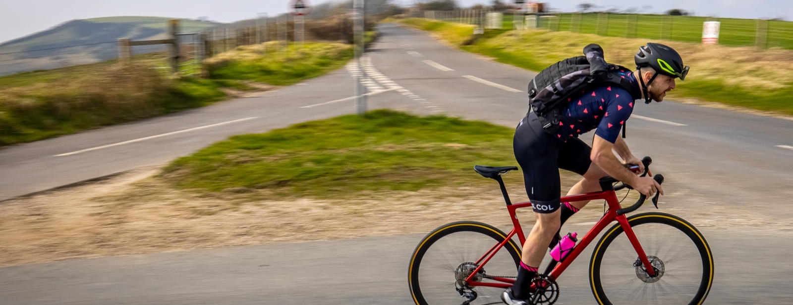 Man on road bike riding on country road