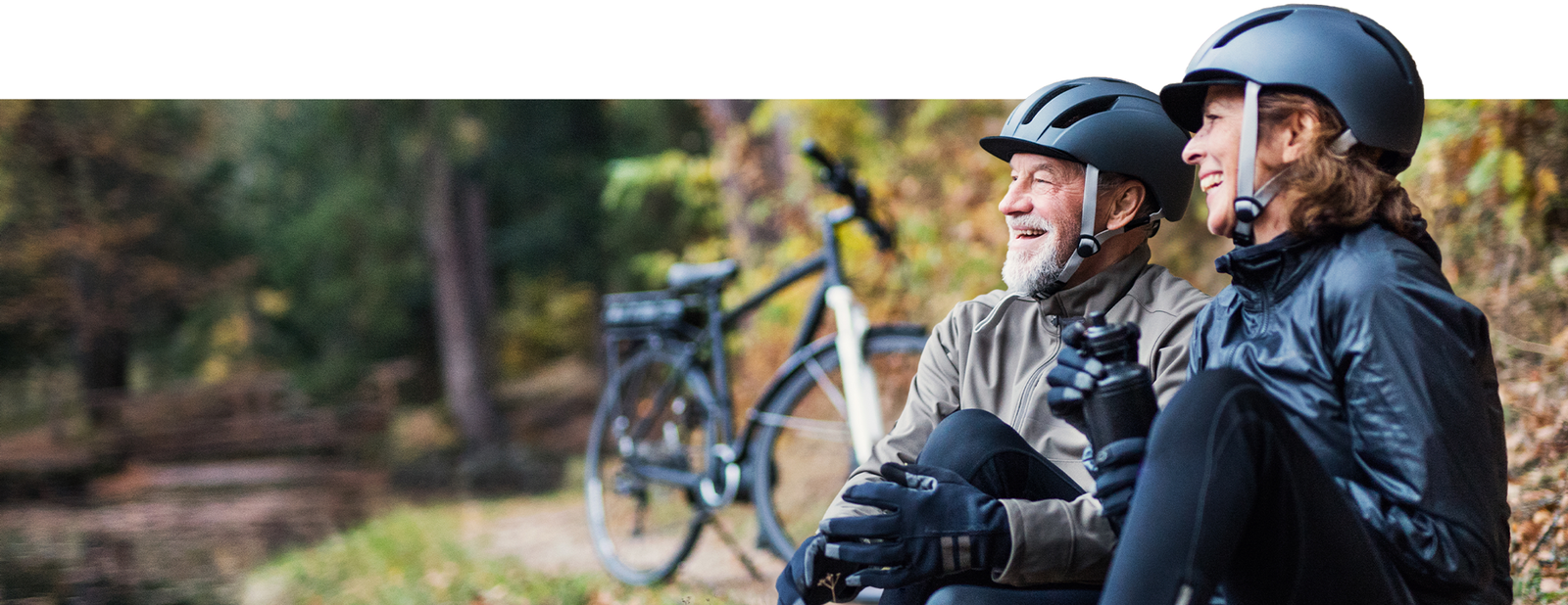 A man and woman taking a break from cycling
