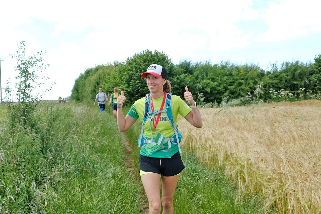 A walker on the challenge going through a field
