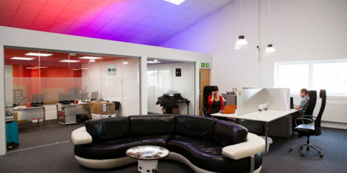 Communal lounge with curved sofa and desks at Barnstaple Work Hub