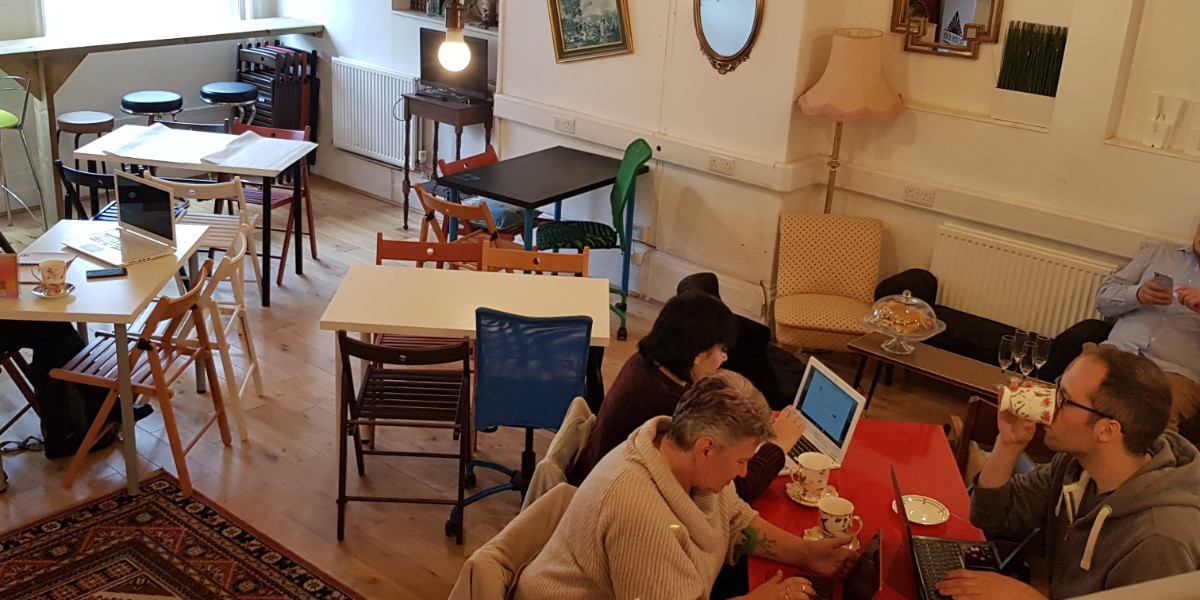 Coworking lounge with tables and sofas at Provident House, Bedford