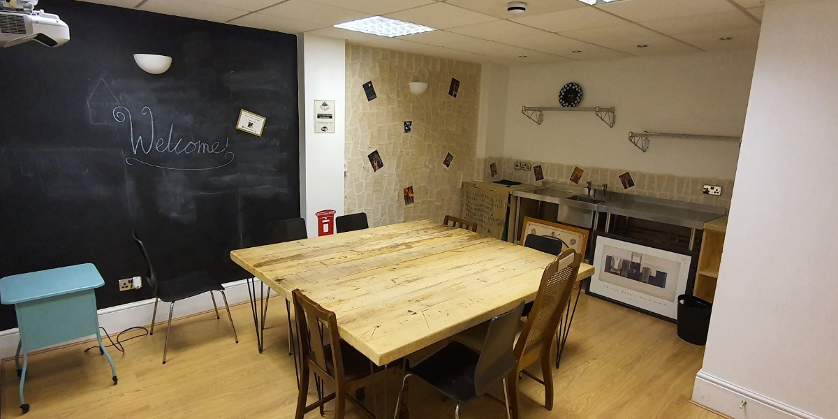Workshop room with a large table and blackboard wall