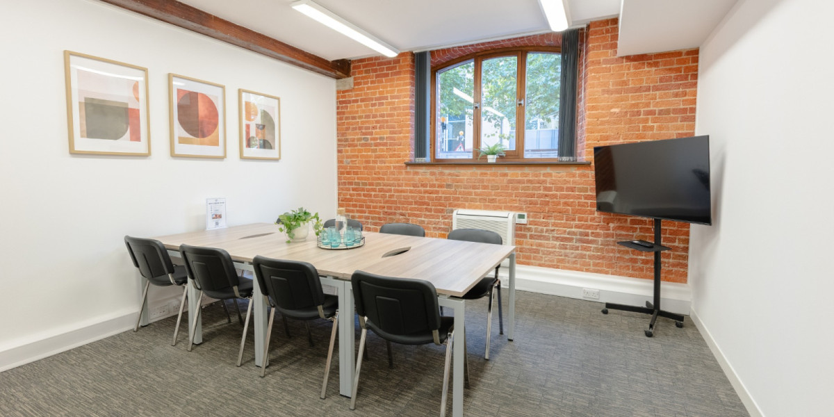 Meeting room with screen and brick feature wall at Enterprise House