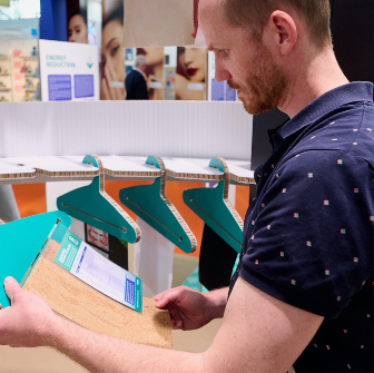Attendee looking at sustainable material in Sustainability Spotligh