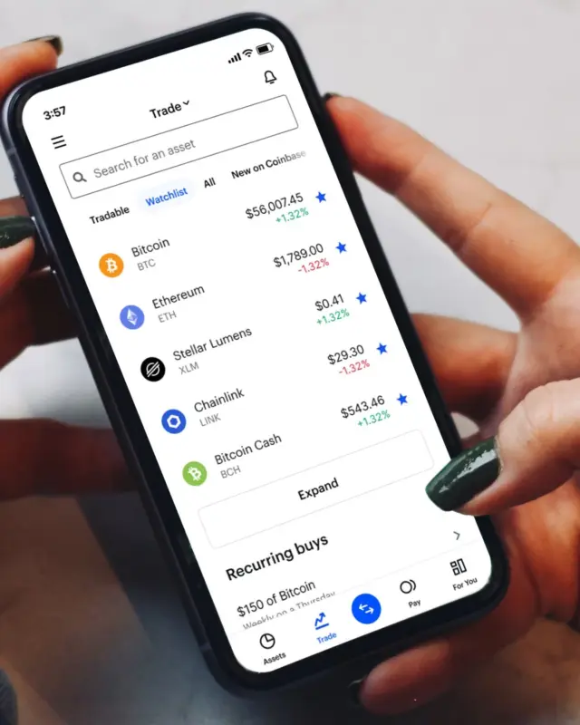 Hands holding a phone showing a crypto portfolio