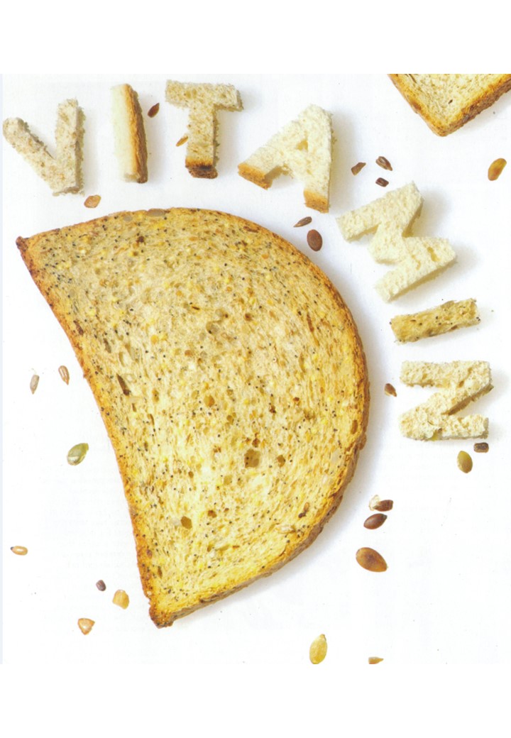 Colour photograph of a slice of bread in the shape of the letter D and the word 'vitamin' cut out of bread