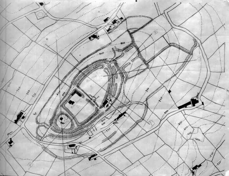 A black and white map showing an ancient fort, oval in shape, surrounded by fields and roads. Dotted lines and structures indicate terrain and buildings.