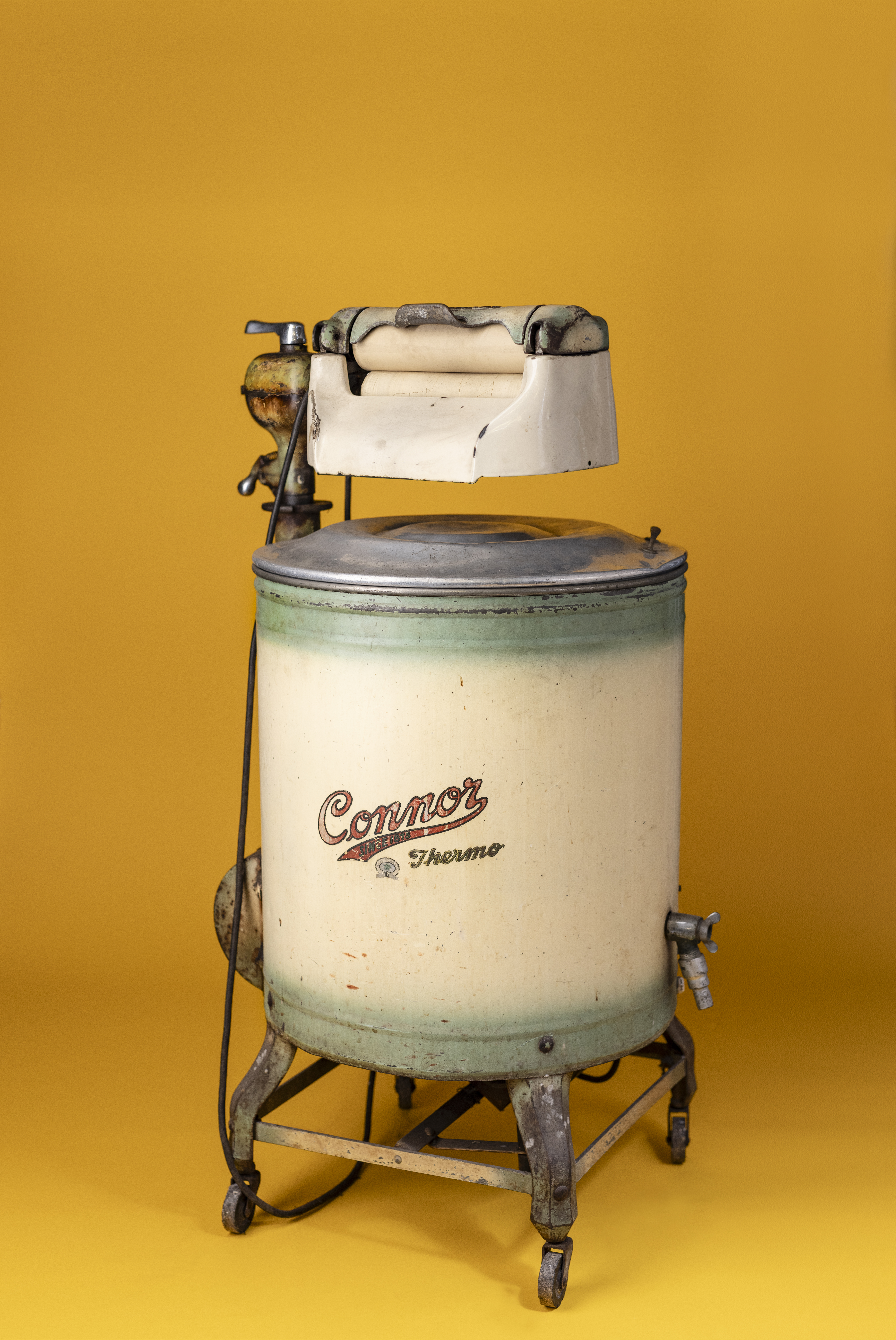 Cylindrical electric powered washing machine with a hand mangle built in above