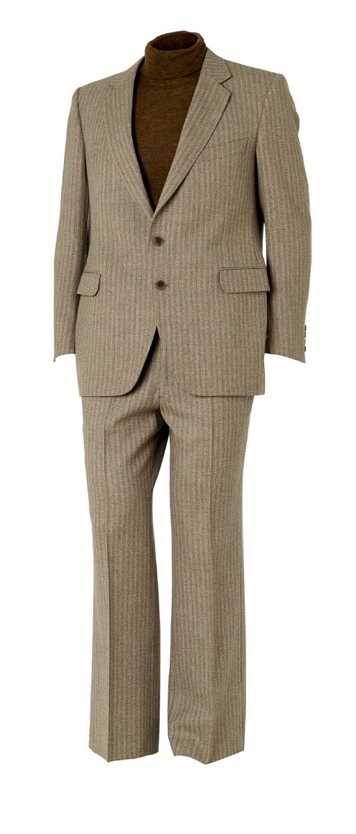 Mannequin wearing a grey two piece suit with a brown polo neck jumper underneath