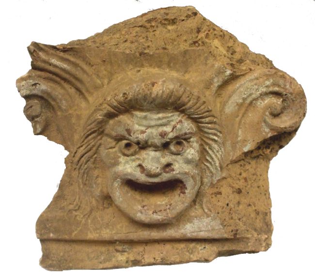 Roman Antefix - slab of stone from a wall depicting a person's face with a menacing grin