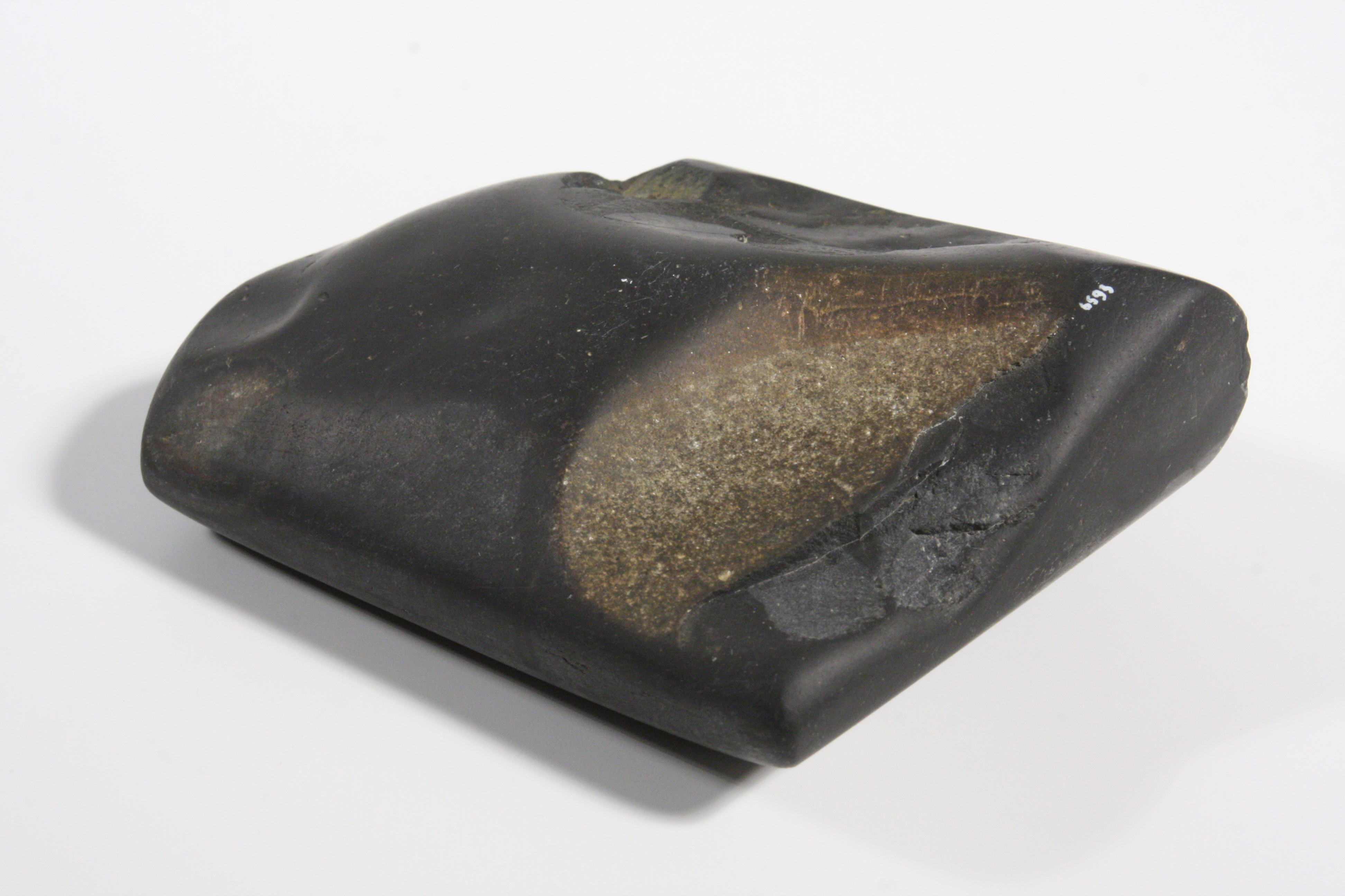 Bronze Age Metal Working Tool roughly square shaped with smoothed edges and indentations