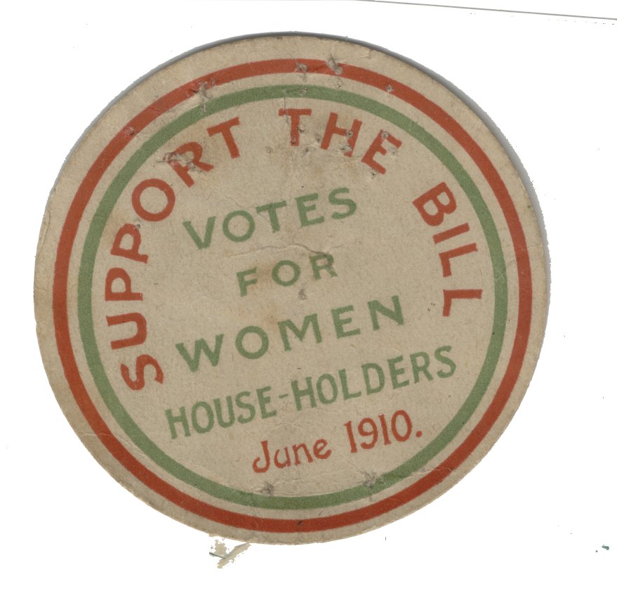 A circular badge reads "Support the Bill, Votes for Women Householders" in bold red and green text, with "June 1910" underneath, and outline stripes in each colour.