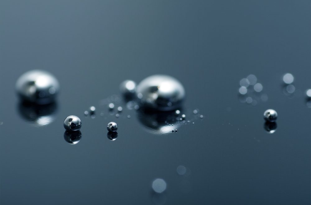 Liquid metal droplets on a background