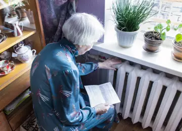 Web woman holding bill and radiator credit i Stock 1126038113