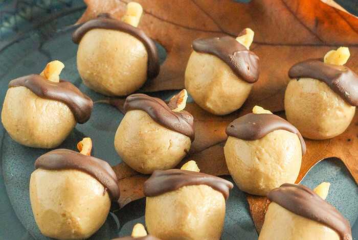 homemade acorn-shaped cookies on a plate for Halloween dog treats