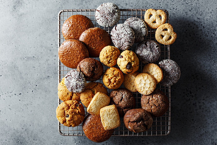 an assortment of cookies and baked treats cooling on a rack