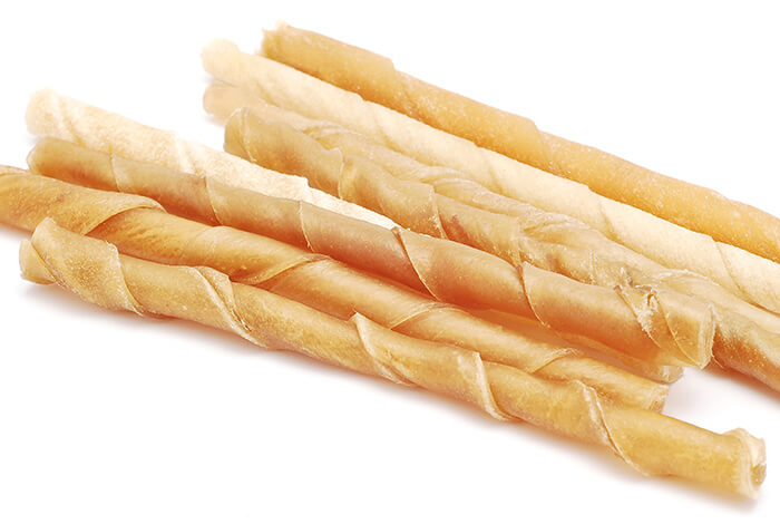 cheese straw dog treats on a white background
