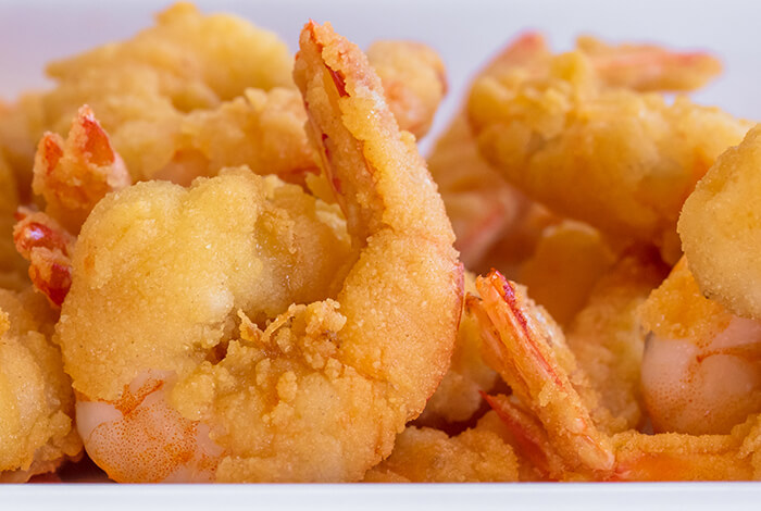 close-up of golden, crispy shrimp popcorn dog treats