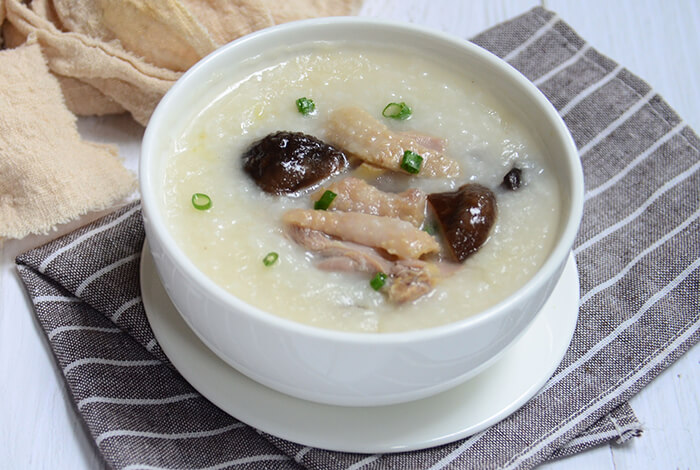 chicken congee in a white soup bowl