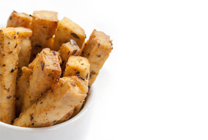 pieces of tofu fries in a white mug