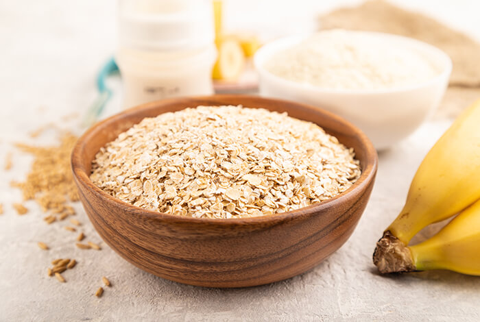 oats in a wooden bowl with bananas on the side