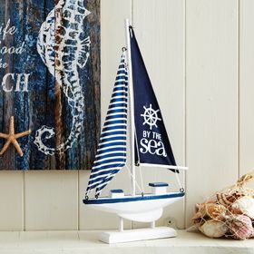 White & Blue Sailboat With Sails - By The Sea
