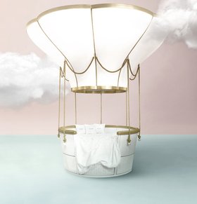 Fantasy Air Balloon | A Crib, Bed and Sofa in this sky blue and pink paint bedding area amidst the clouds
