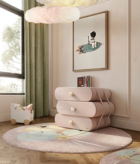 Kids Bedroom | blush pink paint dressing area with Cloud chest of drawers for storage, IV Planets round rug, Cloud pendant lamp, green curtain, wall art, and wood flooring