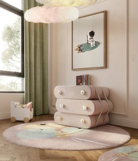 Kids Bedroom | blush pink paint dressing area with Cloud chest of drawers for storage, IV Planets round rug, Cloud pendant lamp, green curtain, wall art, and wood flooring