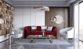 Living Room | cosy elegant reading corner with deep red sofa, brass and glass center table, curvy white armchair, crystal chandelier, and marble flooring