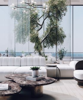 Summer Rooftop Bar by Sarah Done | cosy neutral living room with the brown marble Robusta center table, Cassia modular sofa, Ceylon curvy side table, and vase