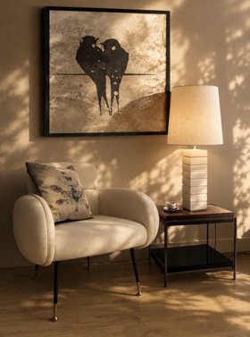 Living Room | cosy neutral reading corner with Aroma brown wood side table for storage, Bombon table lamp, retro white armchair, cushion, wall art, and wood flooring