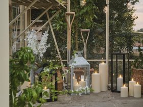 Spring Garden Shed Lifestyle with TruGlow® Outdoor Candles and Lanterns