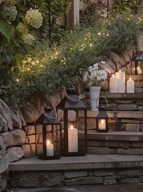 Glowing Spring Evening Lifestyle with TruGlow® Outdoor Candles & Black Garden Lantern