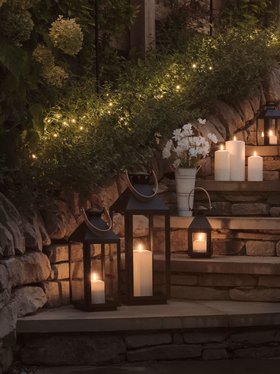 Spring Evening Glowing Lifestyle with TruGlow® Waterproof Outdoor Candles and Black Garden Lantern