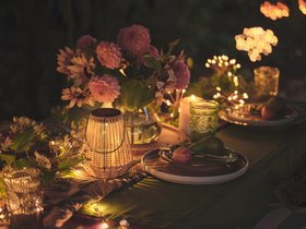 Glowing Spring Summer Dining Table with Wicker Lantern & Flower Garland
