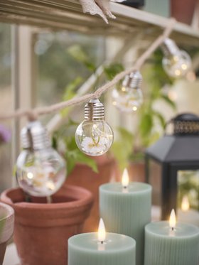 Spring Garden with Daisy Festoon Lights and Sage Green Ribbed TruGlow® Candles