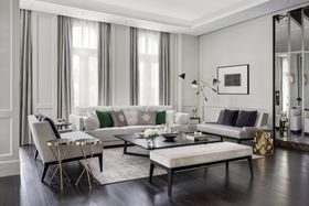 Living Room | spring/summer reading corner in cosy elegant style with Simone retro floor lamp, gold side table, white sofa, dark center table, ottoman, curtain, and wood flooring