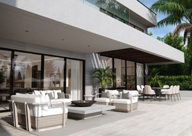 Outdoors | outdoor garden area with Hampton rattan sofa, Hampton armchair, fire pit table, grey rug, and wood flooring