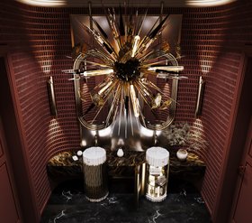 Bathroom | deep red paint luxury bathroom in dark marble finishes with Symphony white pedestal sink and cabinet for storage, Colosseum curvy gold wall mirror, Outburst chandelier, Cyrus wall lamp, and vase