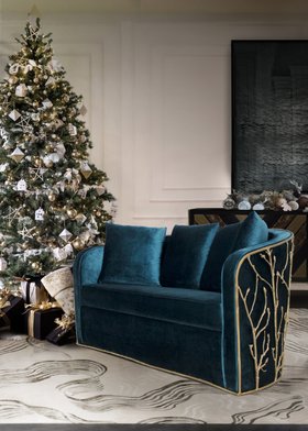 Christmas Season | cosy living room with Enchanted curvy deep blue sofa, cushion, and christmas tree
